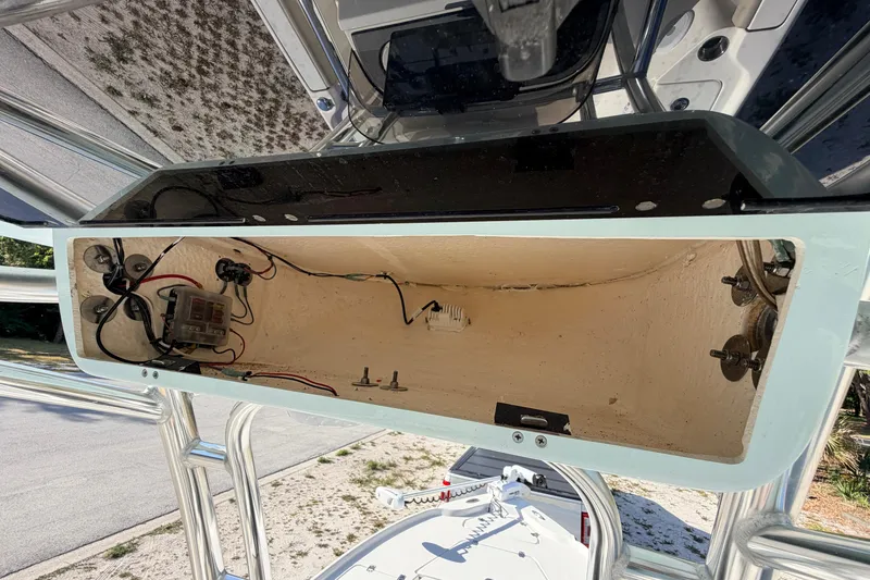 Slide: The Image of 2024 Key West 210 Bay Reef boat compartment with wiring and components visible. - 81