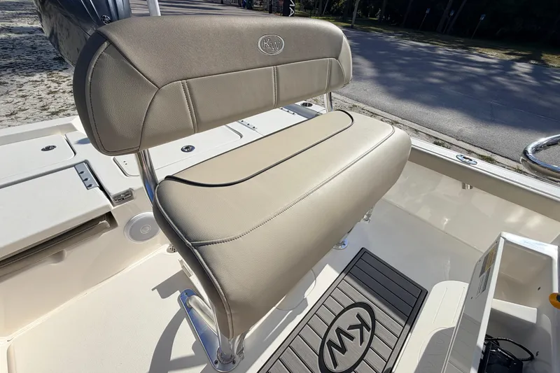 Slide: The Image of 2024 Key West 210 Bay Reef boat interior with cushioned seating and KW logo mat. - 83