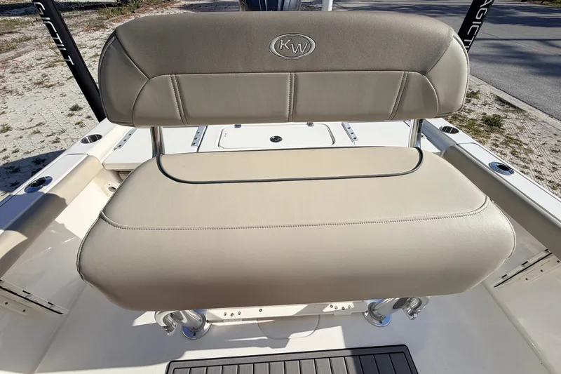 Slide: The Image of 2024 Key West 210 Bay Reef boat seat with beige upholstery and KW logo. - 84
