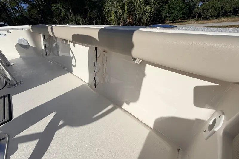 Slide: The Image of 2024 Key West 210 Bay Reef boat interior with rod holders and cushioned seating. - 87