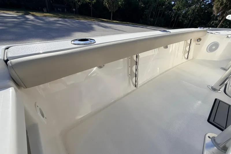 Slide: The Image of 2024 Key West 210 Bay Reef boat interior with rod holders and cushioned side panel. - 88