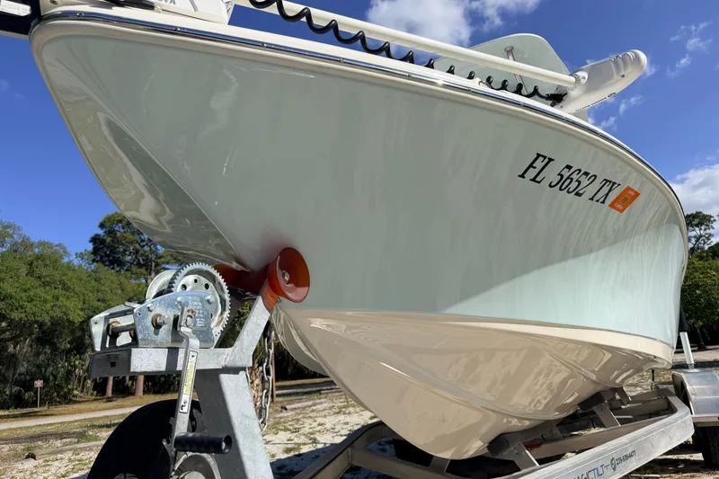 Slide: The Image of 2024 Key West 210 Bay Reef boat on trailer, sunny day, registration visible. - 9