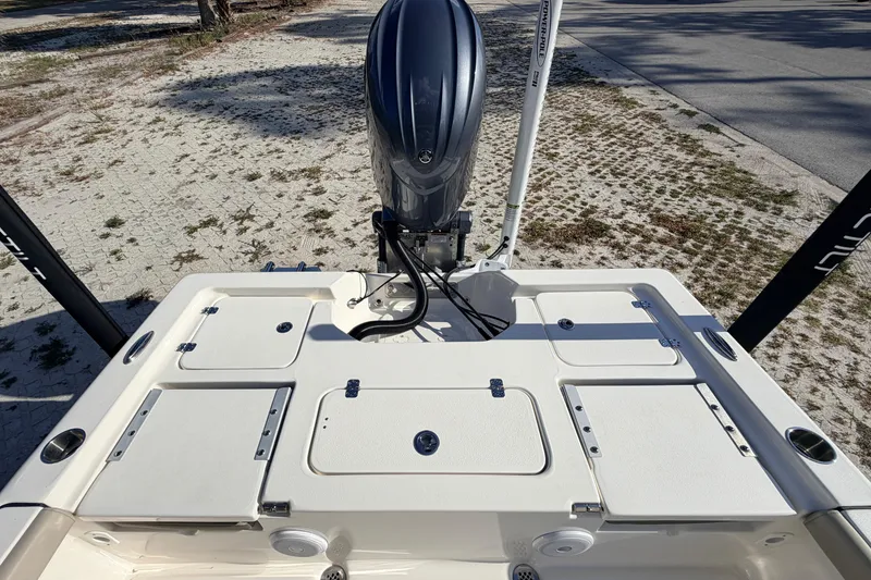 Slide: The Image of 2024 Key West 210 Bay Reef boat with outboard motor and storage compartments. - 92