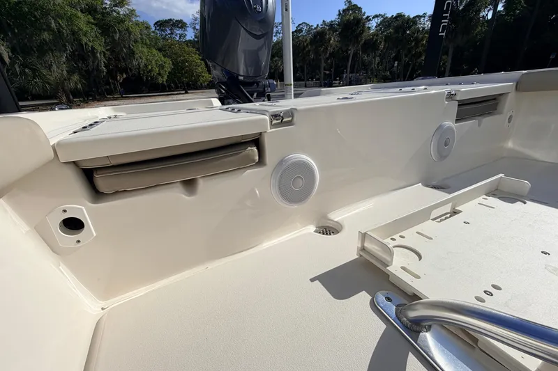 Slide: The Image of 2024 Key West 210 Bay Reef boat interior with speakers and storage compartments. - 94