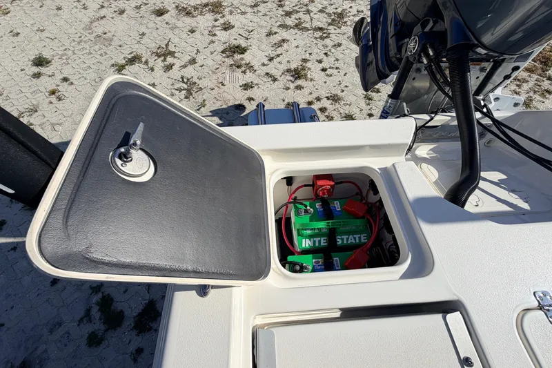 Slide: The Image of 2024 Key West 210 Bay Reef boat battery compartment with Interstate battery visible. - 99
