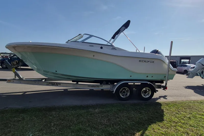 Slide: The Image of 2015 Sea Fox 226 Traveler boat on trailer, parked outdoors under clear sky. - 4