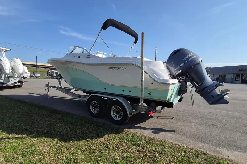 Slide: The Image of 2015 Sea Fox 226 Traveler boat on trailer with Yamaha outboard motor, parked outdoors. - 5