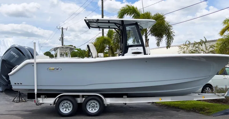 The Image of 2023 Sea Hunt Gamefish 27 with Coffin Box on trailer, parked outdoors. - 0
