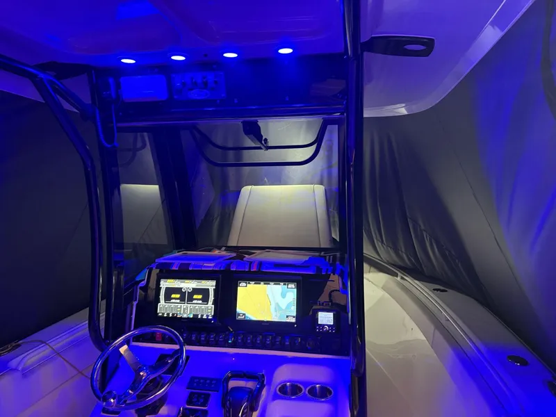 Slide: The Image of 2023 Sea Hunt Gamefish 27 cockpit with illuminated controls and navigation screens. - 10