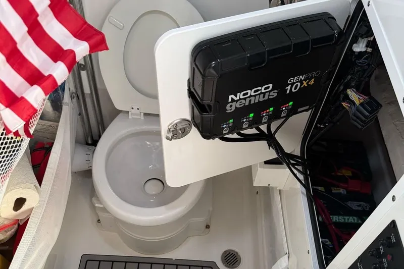 Slide: The Image of 2023 Sea Hunt Gamefish 27 boat interior with toilet and NOCO Genius charger. - 12