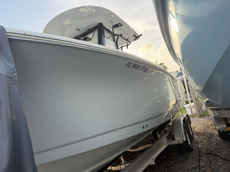 Slide: The Image of 2023 Sea Hunt Gamefish 27 with Coffin Box on trailer, side view. - 17