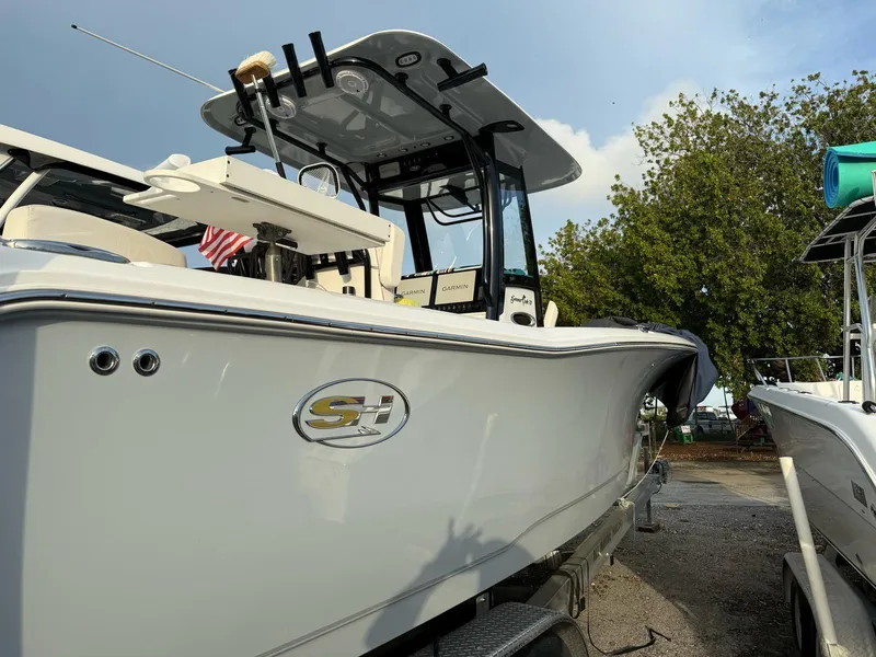Slide: The Image of 2023 Sea Hunt Gamefish 27 with Coffin Box, docked, side view, under clear sky. - 19