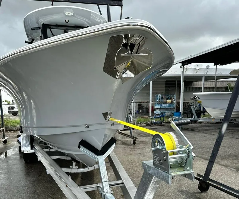 Slide: The Image of 2023 Sea Hunt Gamefish 27 with Coffin Box on trailer, front view, overcast sky. - 2