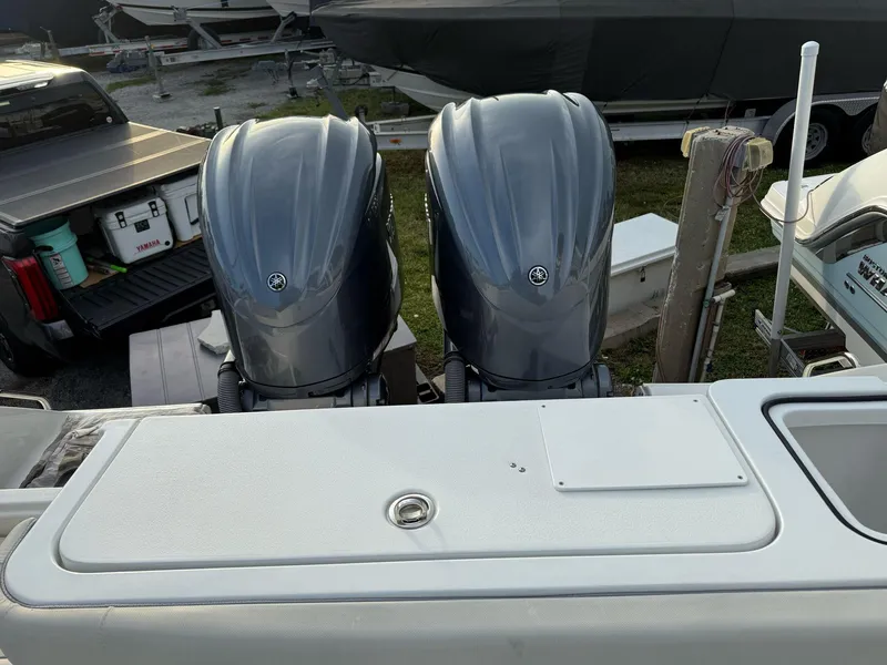 Slide: The Image of 2023 Sea Hunt Gamefish 27 with Coffin Box, featuring dual outboard engines. - 6