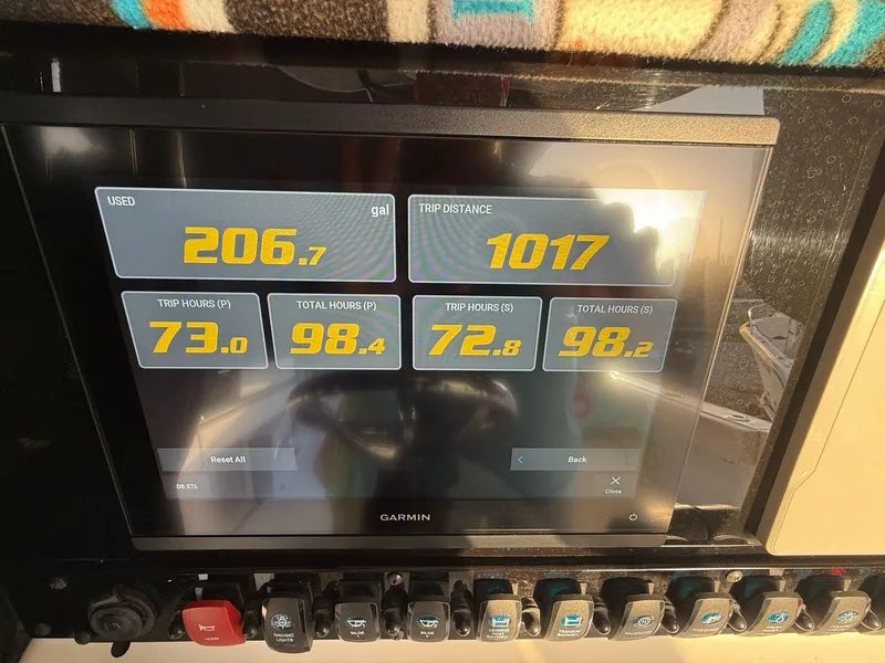 Slide: The Image of 2023 Sea Hunt Gamefish 27 dashboard displaying fuel usage and trip data on Garmin screen. - 9