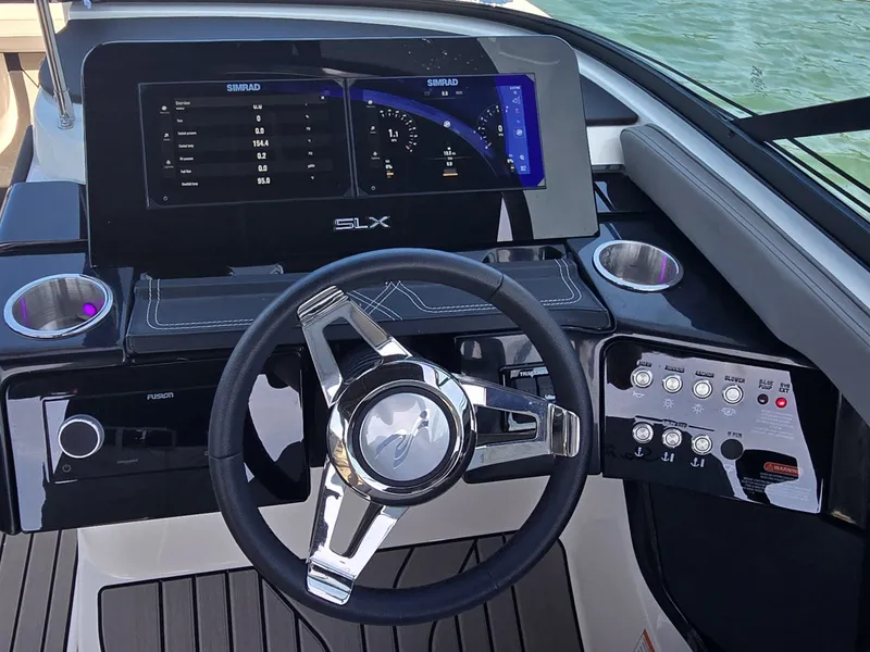 Slide: The Image of The image shows the helm of a Sea Ray SLX 260 Surf boat with modern instruments. - 15