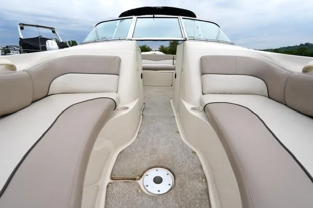 Slide: The Image of 2002 Sea Ray 190 Sundeck interior with beige seating and open deck layout. - 11
