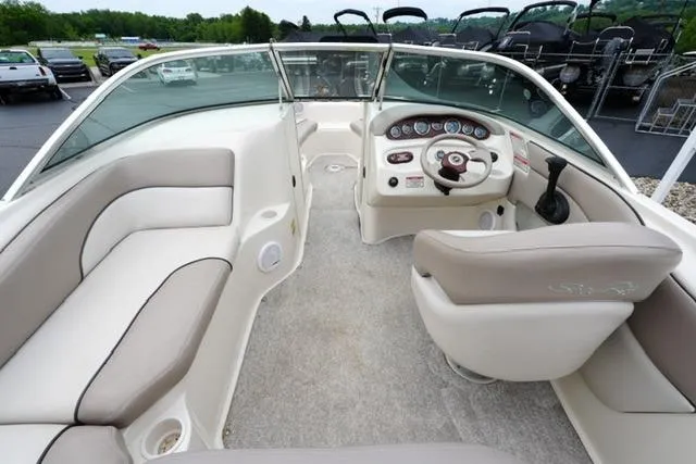 Slide: The Image of Interior view of a 2002 Sea Ray 190 Sundeck boat with beige seating and dashboard. - 12
