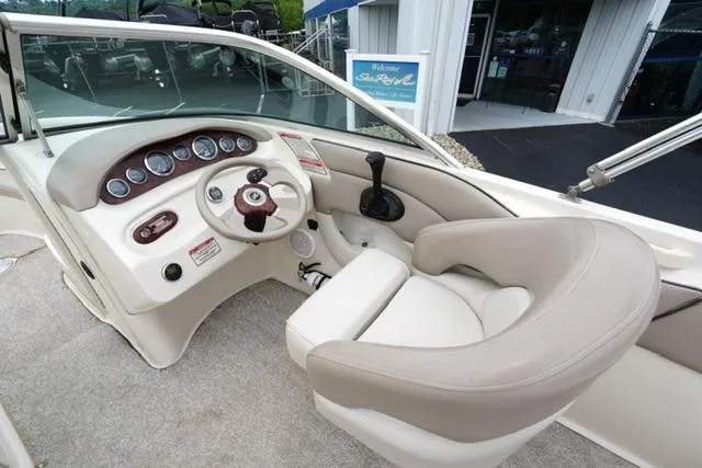 Slide: The Image of 2002 Sea Ray 190 Sundeck boat interior with steering wheel and dashboard controls. - 13