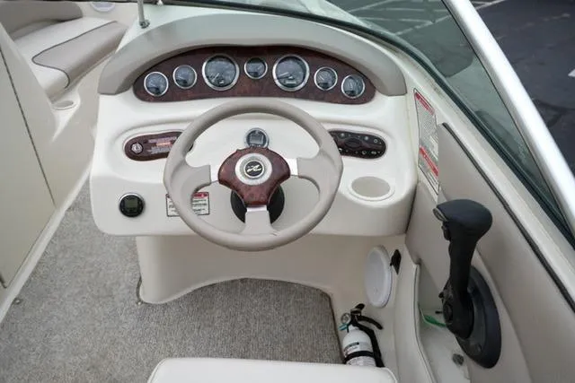 Slide: The Image of 2002 Sea Ray 190 Sundeck boat dashboard with steering wheel and instrument panel. - 14