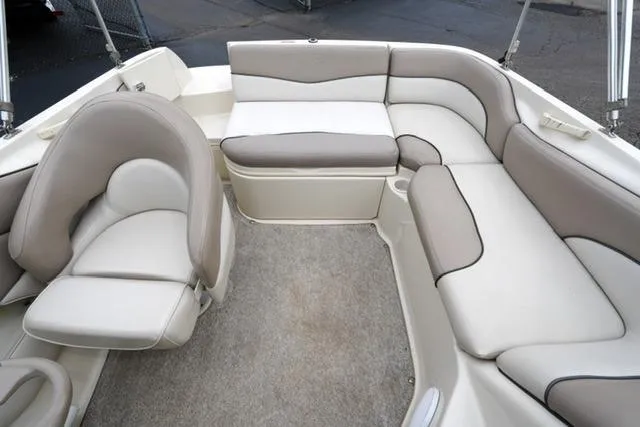 Slide: The Image of Interior of a 2002 Sea Ray 190 Sundeck boat with beige seating. - 15
