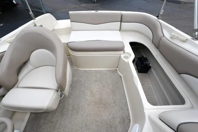 Slide: The Image of Interior of 2002 Sea Ray 190 Sundeck boat with beige seating and storage. - 16