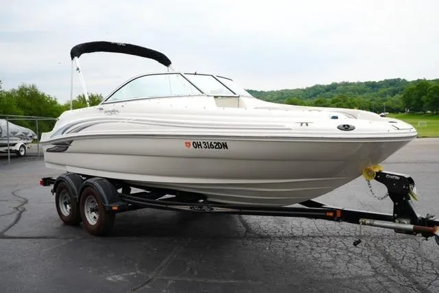 Slide: The Image of 2002 Sea Ray 190 Sundeck boat on trailer, parked outdoors. - 3