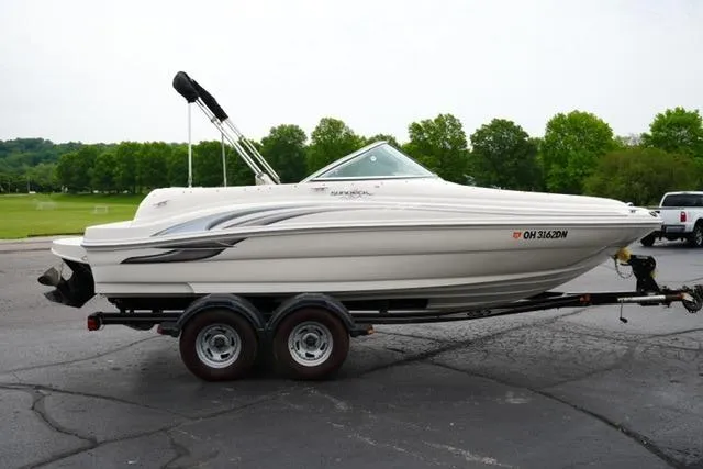 Slide: The Image of 2002 Sea Ray 190 Sundeck boat on trailer, parked outdoors. - 4
