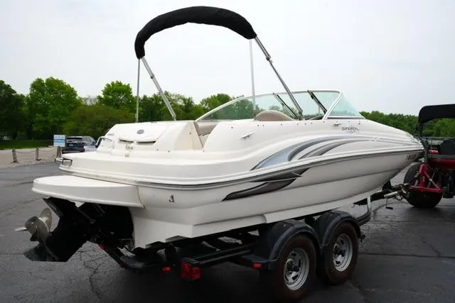 Slide: The Image of 2002 Sea Ray 190 Sundeck boat on trailer, parked outdoors. - 5