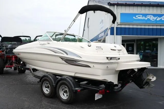 Slide: The Image of 2002 Sea Ray 190 Sundeck boat on trailer, parked outside dealership. - 7