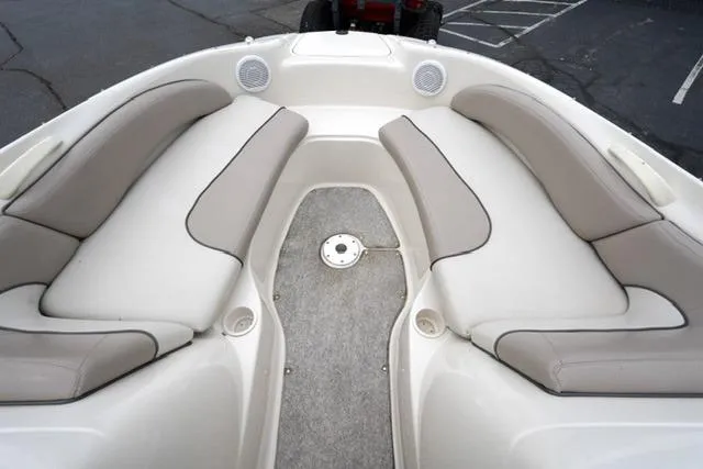 Slide: The Image of 2002 Sea Ray 190 Sundeck interior with beige seating and speakers. - 9