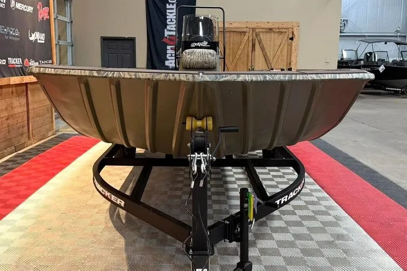 Slide: The Image of 2026 Tracker Grizzly 2072 CC boat on trailer in showroom setting. - 3