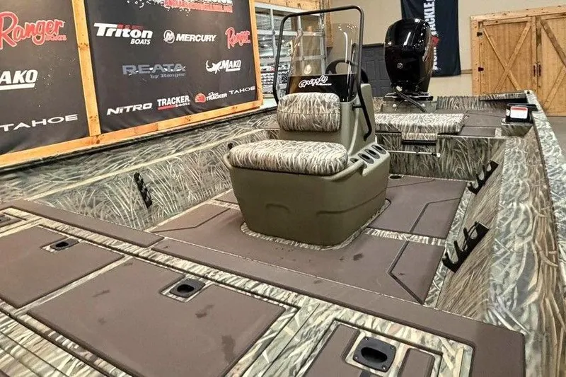 Slide: The Image of 2026 Tracker Grizzly 2072 CC boat interior with camouflage seating and storage compartments. - 7