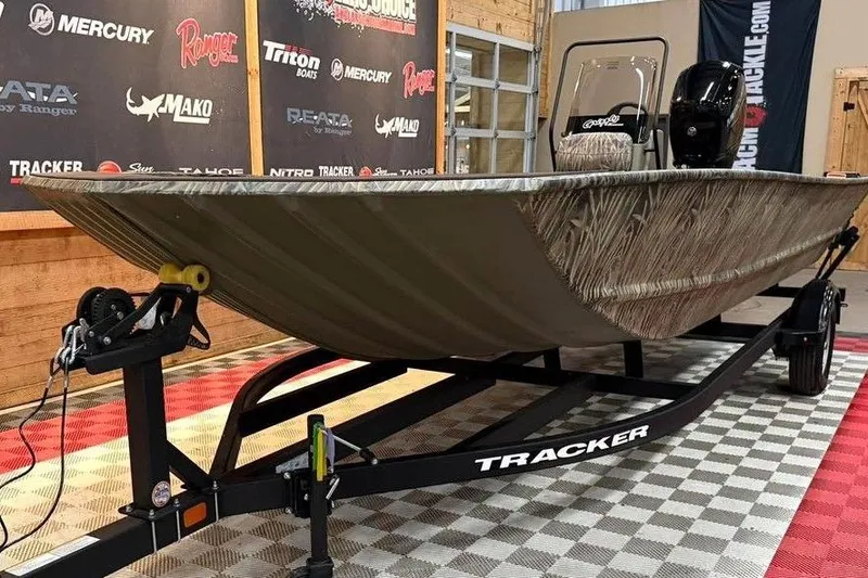 Slide: The Image of 2026 Tracker Grizzly 2072 CC boat on display with camouflage design and trailer. - 8