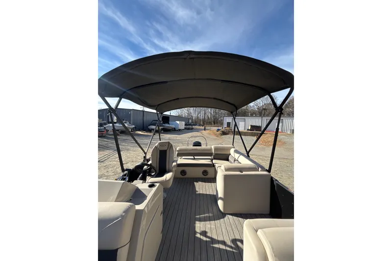 Slide: The Image of 2023 Harris Cruiser 230 pontoon boat interior with canopy, showcasing seating and helm. - 16