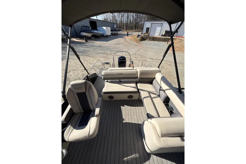 Slide: The Image of 2023 Harris Cruiser 230 pontoon boat interior with beige seating and canopy. - 17