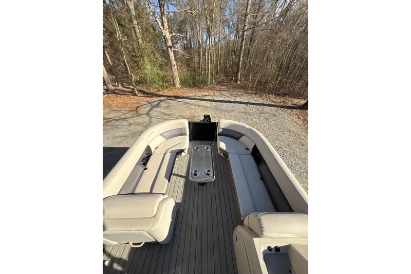 Slide: The Image of 2023 Harris Cruiser 230 boat interior with beige seating and wooded surroundings. - 19