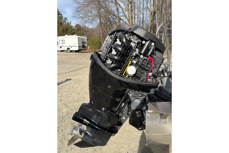 Slide: The Image of 2023 Harris Cruiser 230 outboard motor, detailed view in a sunny outdoor setting. - 25