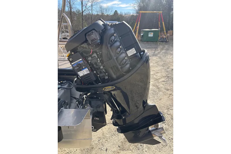 Slide: The Image of 2023 Harris Cruiser 230 outboard motor in a sunny outdoor setting. - 26