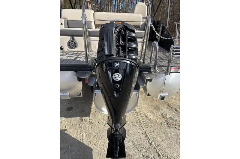 Slide: The Image of 2023 Harris Cruiser 230 boat with powerful outboard motor, rear view. - 27