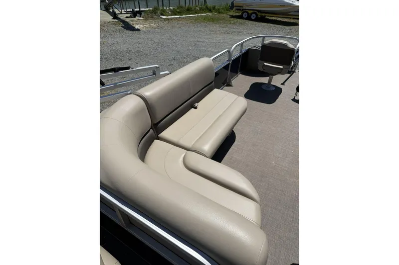 Slide: The Image of 2024 Sun Tracker Bass Buggy 18 DLX pontoon boat with beige seating and spacious deck. - 5