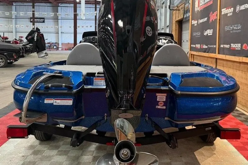 Slide: The Image of 2026 Nitro Z17 boat in showroom, featuring sleek blue design and powerful outboard motor. - 4