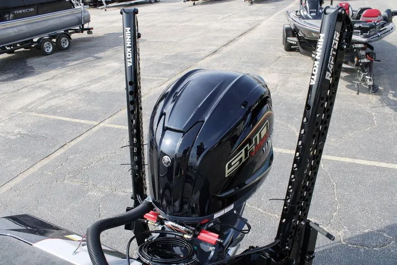 Slide: The Image of 2026 Skeeter ZXE21 boat with Minn Kota Raptor anchors in a parking lot. - 22