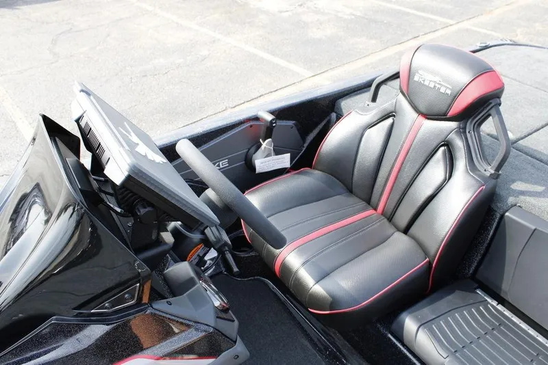 Slide: The Image of 2026 Skeeter ZXE21 boat cockpit with black and red seating and modern dashboard. - 25