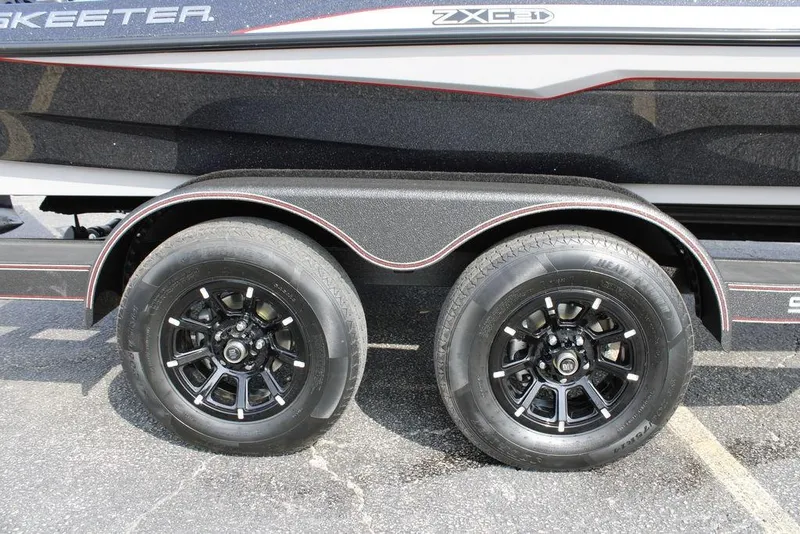 Slide: The Image of 2026 Skeeter ZXE21 trailer with dual black alloy wheels and sleek design. - 7