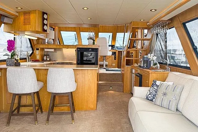 Slide: The Image of Luxurious 1995 Symbol Pilothouse yacht interior with modern kitchen, seating, and elegant decor. - 1