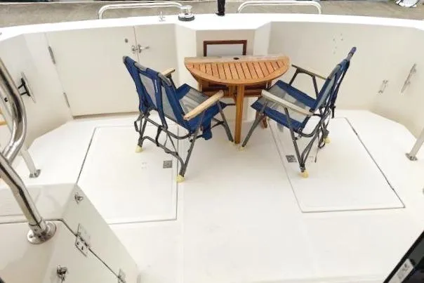 Slide: The Image of 1995 Symbol Pilothouse deck with table and chairs. - 13