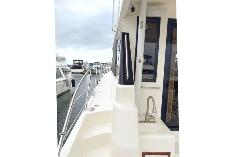 Slide: The Image of 1995 Symbol Pilothouse boat with railing and sink in harbor. - 14