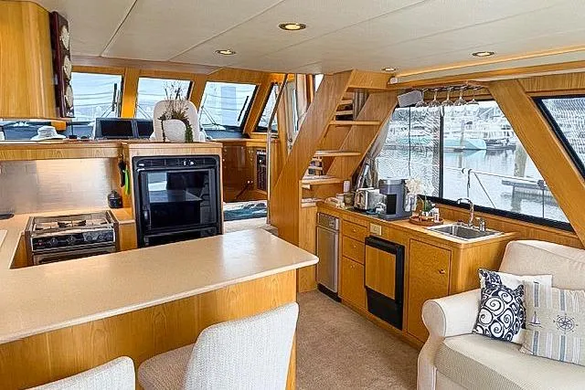 Slide: The Image of Luxurious 1995 Symbol Pilothouse yacht interior with modern kitchen and cozy seating area. - 19