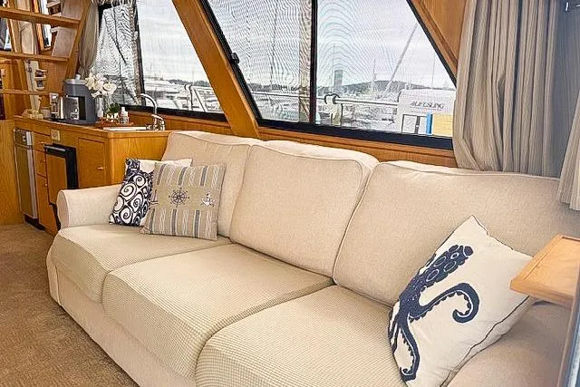 Slide: The Image of Luxurious 1995 Symbol Pilothouse interior with beige sofa and nautical-themed pillows. - 20